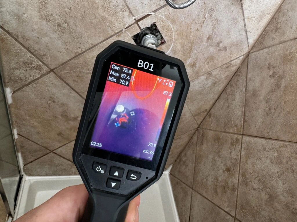 Technician using a moisture meter during a mold inspection